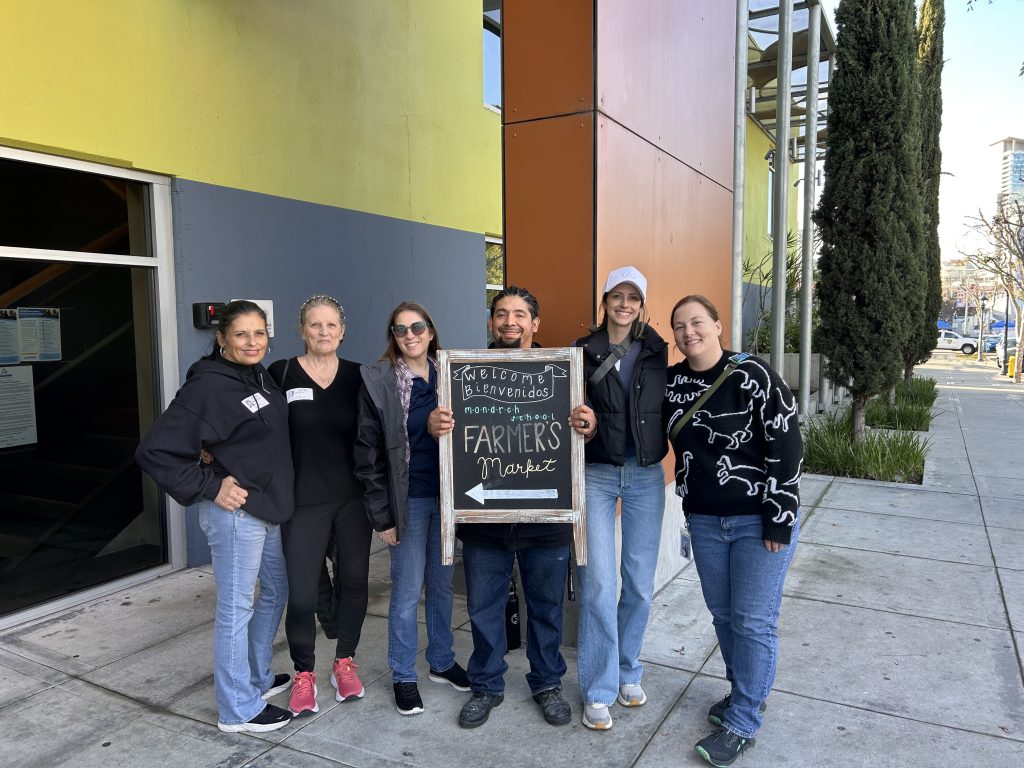 Strat Property Management team members at the Monarch School Farmers Market in 2026