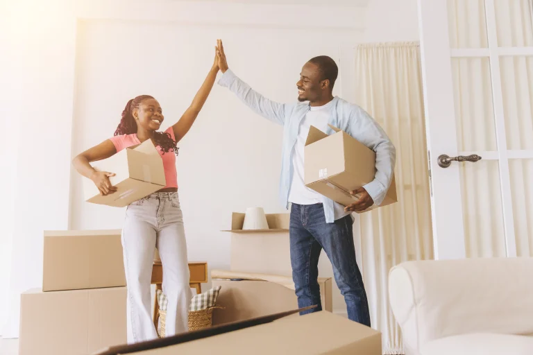 New residents celebrating move-in day in their home, representing the tenant resources and services available through Strat Property Management.